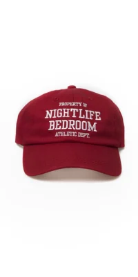 A red baseball cap with white text on the front.
